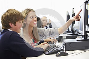 Teacher And Pupil In School Computer Class