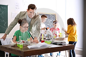 Teacher with pupils at chemistry lesson