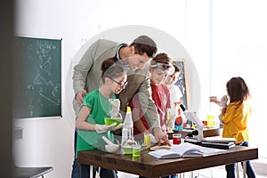 Teacher with pupils at chemistry lesson