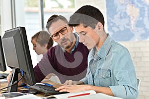 Teacher and pupils in computing class