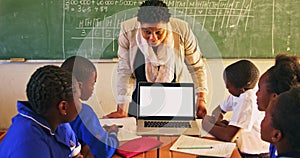 Teacher and pupils with laptop in class 4k