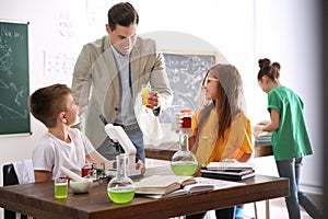 Teacher with pupils at lesson in classroom