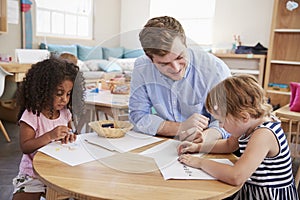 Teacher And Pupils Practicing Writing In Montessori School