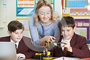 Teacher With Pupils In Science Lesson Studying Robotics