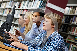 teacher and pupils working on computers photo