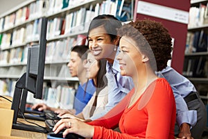 teacher and pupils working on computers photo