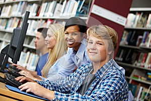 teacher and pupils working on computers