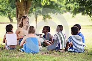 Teacher reading book to elementary students