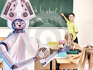 Teacher robot with school children in school class near blackboard.