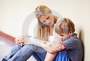 Teacher, sad student and talking at school for support, trust or counselling. A woman working with a child for