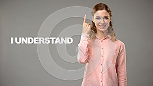Teacher saying i understand in asl, text on background, communication for deaf photo