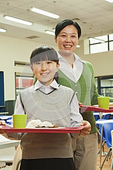Teacher and school girl portrait in school cafeteria