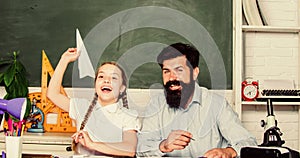 Teacher and schoolgirl. Man bearded pedagogue and pupil having fun. Developing caring learners who are actively growing
