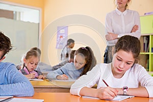 Teacher and schoolkids during lesson