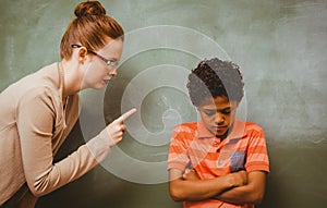 Teacher shouting at boy in classroom photo