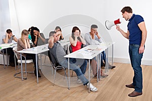 Teacher shouting through megaphone on university students