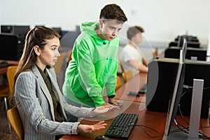 Teacher shows the student how to solve the problem on computer