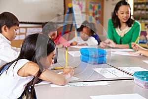 Teacher sitting with kids in elementary school lesson