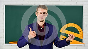 Teacher smart man at chalkboard young leader, education reforms concept