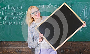 Teacher smart smiling woman hold blackboard blank advertisement copy space. School schedule and information. Hometask photo