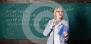 Teacher smart woman with book explain topic near chalkboard. What makes great teacher. School teacher explain things
