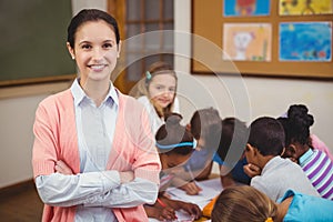 Teacher smiling at camera in classroom