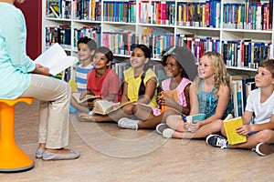 Teacher with smiling children in library