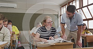 Teacher speaking to a student in class