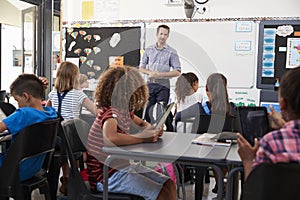 Teacher standing in front of elementary school class