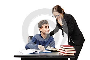 Teacher standing next to the student's desk and the student poi