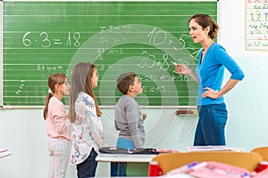 Teacher and student at the blackboard, math class