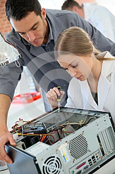 Teacher with student girl in computing