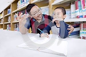 Teacher and student studying math in the library