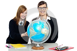 Teacher and student viewing globe