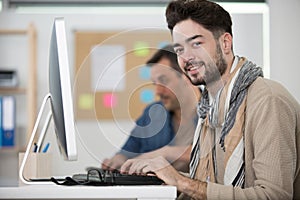 teacher and student working on computer