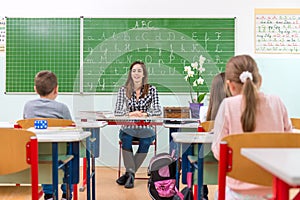 Teacher and students in the classroom: teaching