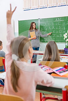 Teacher and students in the classroom: teaching