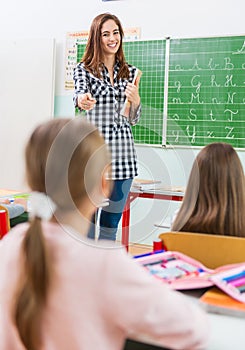 Teacher and students in the classroom: teaching