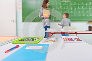 Teacher and students in the classroom: teaching