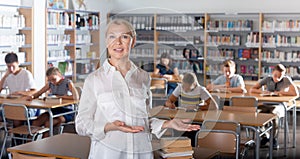 Teacher and students in college library