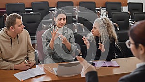 The teacher and students communicate in sign language in the classroom. Hearing impaired and deaf people