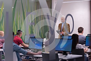 Teacher and students in computer lab classroom