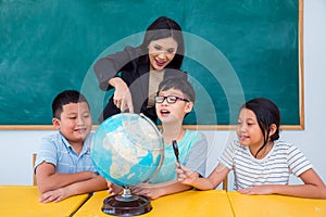 Teacher and students studying geography in class