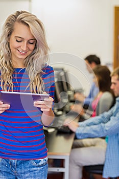 Teacher with students using computers in computer room