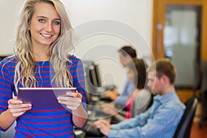 Teacher with students using computers in computer room