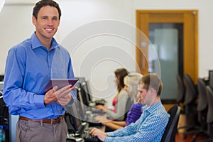 Teacher with students using computers in computer room