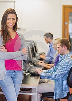 Teacher with students using computers in computer room