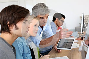 Teacher with students using electronical devices