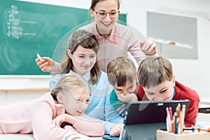 Teacher and students using media and technology in classroom