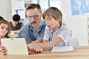 Teacher and students using tablet